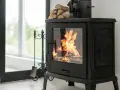 Poêle à bois crépitant, optimisant le pouvoir calorifique du pellet pour une chaleur réconfortante. Un ventilateur et du bois sont prêts à l'emploi.
