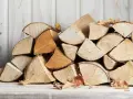 Un tas de bois de chauffage, prêt pour l'hiver. Le charme rustique du bois sec promet des soirées douillettes.