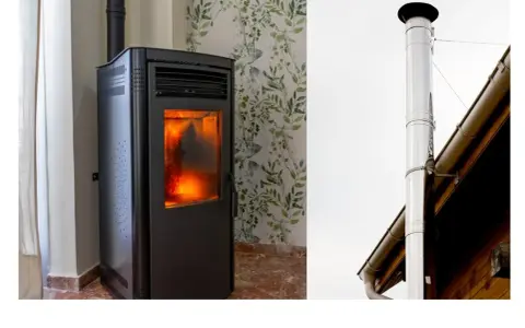Poêle à granulés allumé, avec son conduit d'évacuation. Le diamètre du tubage poêle à granulés est crucial pour une bonne évacuation.